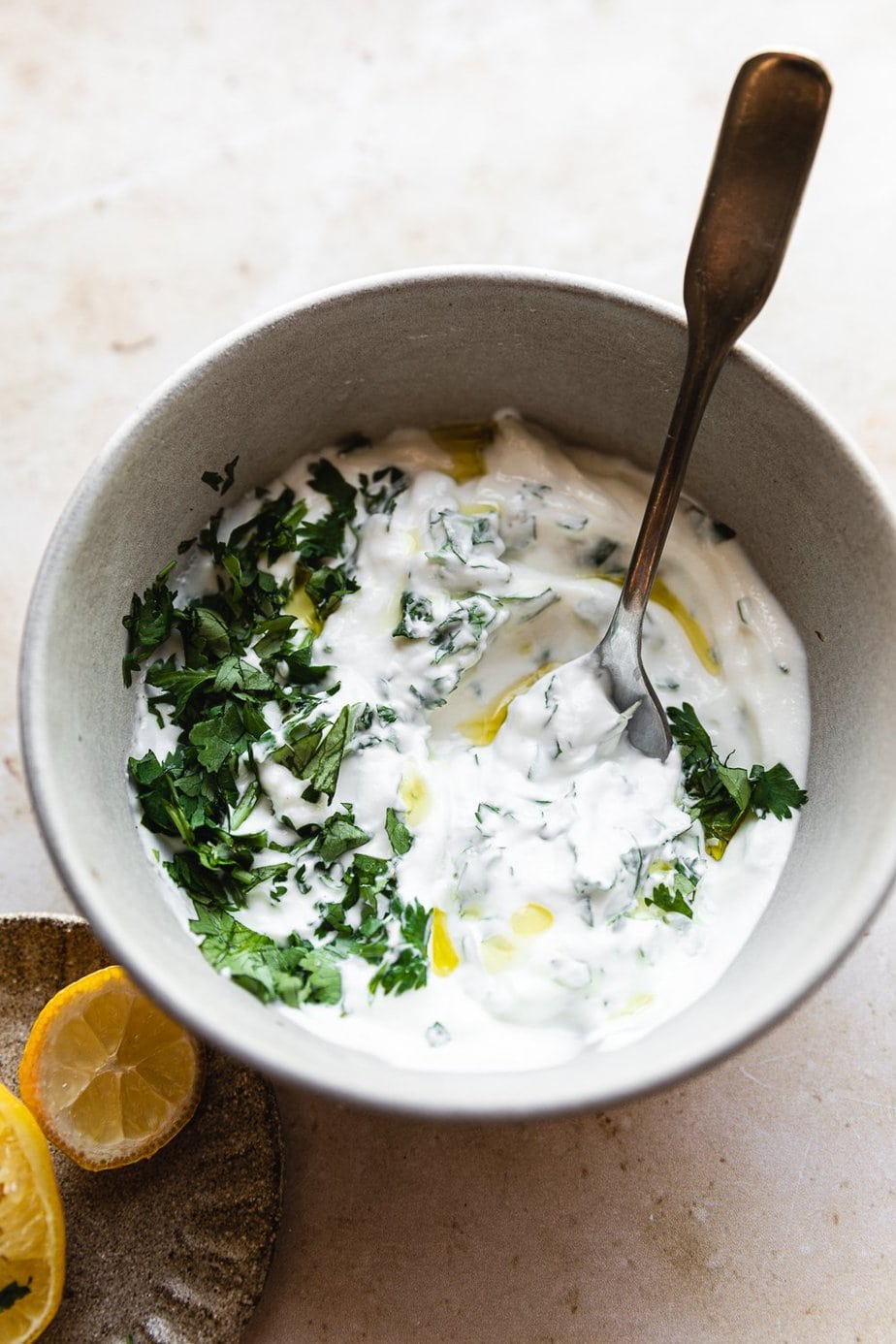 Greek yogurt with cilantro and lemons in a bowl