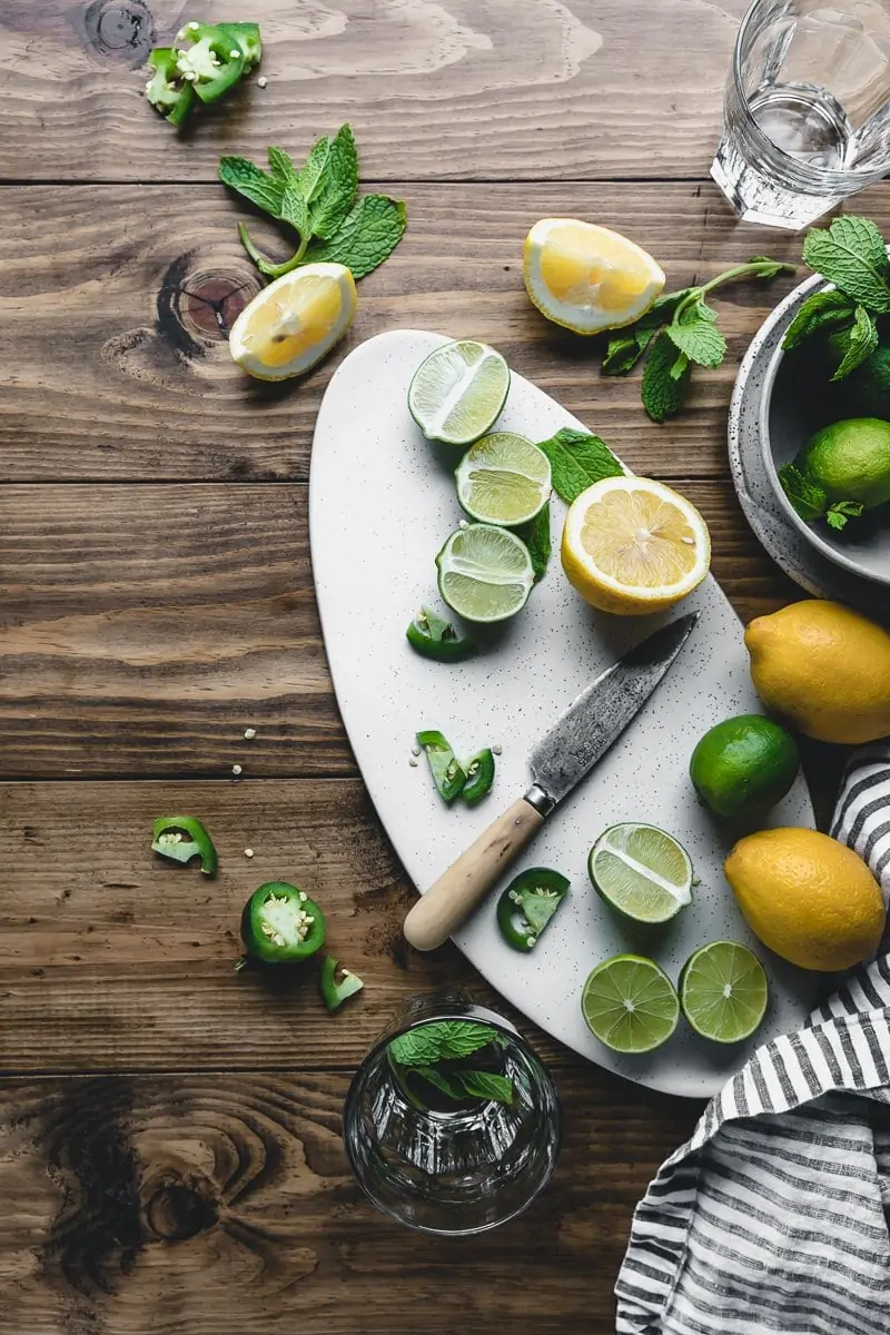 flatlay of limes and lemons on a wood table