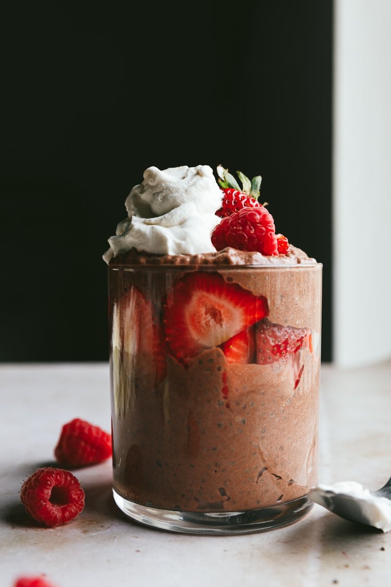 keto chocolate chia pudding with berries and whipped cream