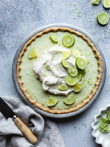 keto key lime pie with lime slices, a linen and knife