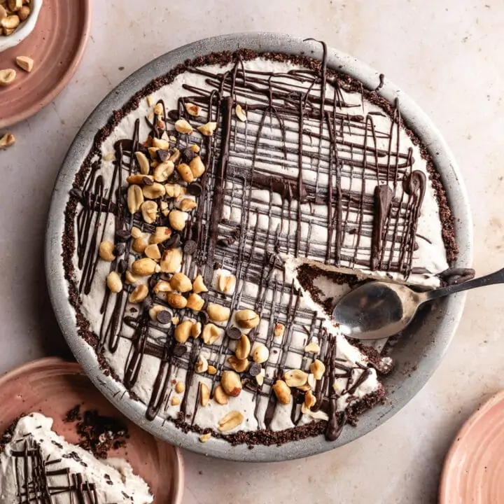 overhead image of keto peanut butter ice cream pie with plates around it