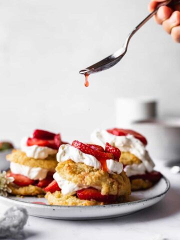 sauce dripping off spoon onto low-carb strawberry shortcake