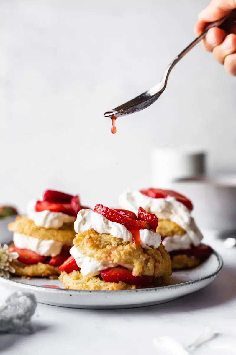 sauce dripping off spoon onto low-carb strawberry shortcake