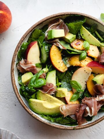 overhead image of half bowl of low-carb summer peach salad