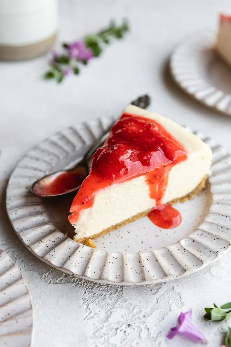 slice of keto cheesecake with strawberry topping on a plate