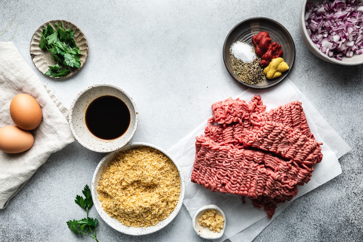 Ingredients arranged in a flat lay for keto meatloaf recipe without bread crumbs.