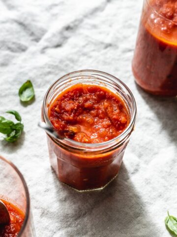 low carb tomato sauce in a jar with basil leaves