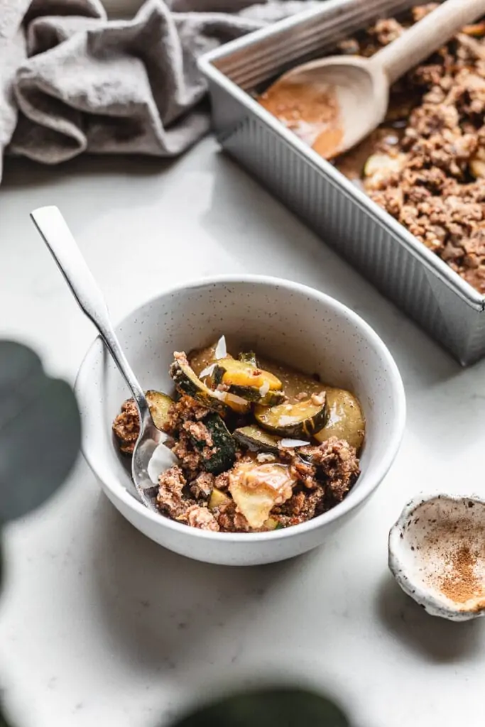 bowl of keto apple zucchini crisp with a spoon