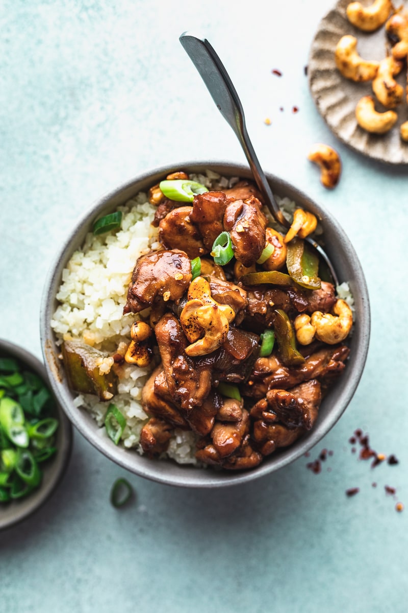 Keto cashew chicken in a bowl with toppings. 
