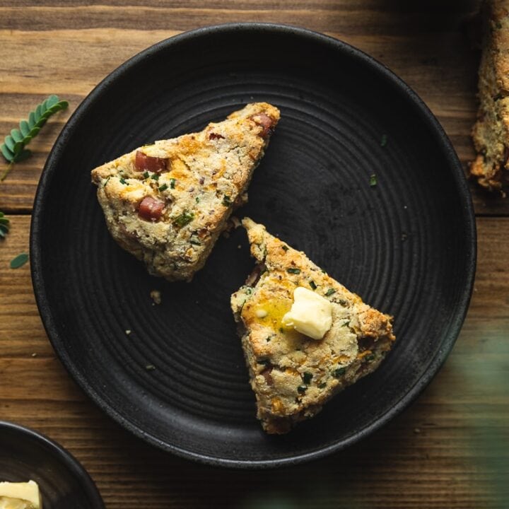 savory keto scones on a black plate with coffee