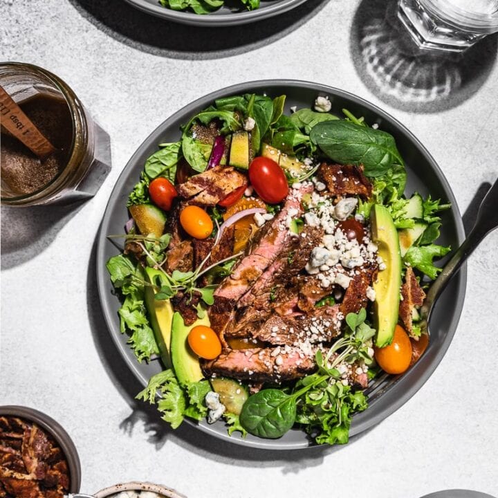 keto steak salad flatlay with ingredients and water glasses
