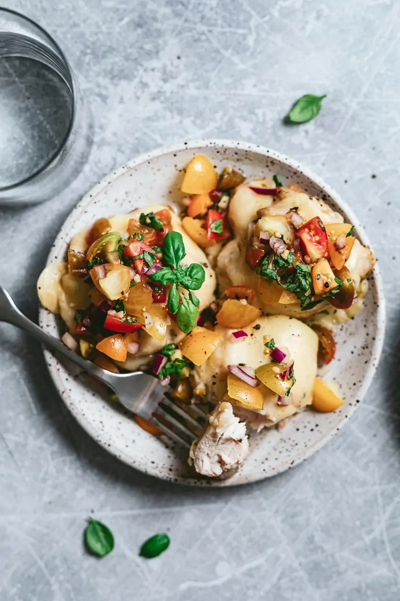 Low-carb bruschetta chicken bake on a plate with basil.