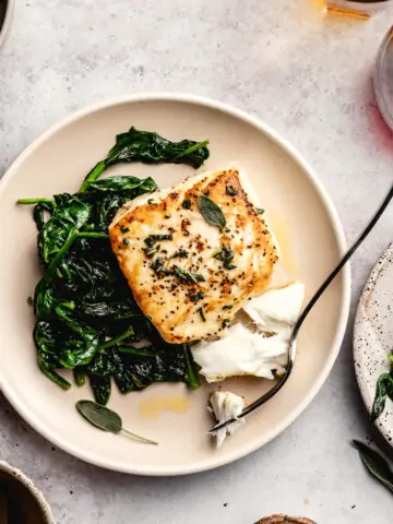 pan-friend halibut on a plate with spinach