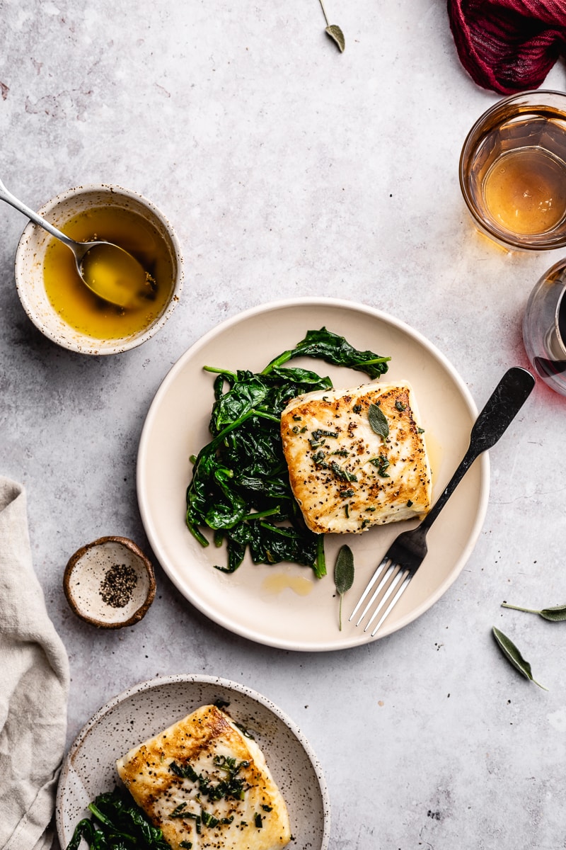flatlay style of pan-seared halibut with brown butter on a plate