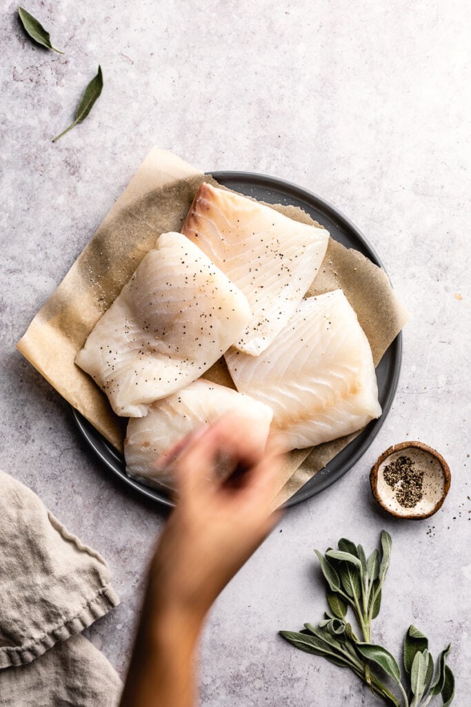 flatlay style showing salt and pepper on halibut