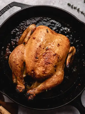 whole roasted chicken in a cast iron skillet