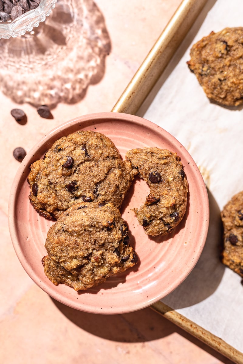 three healthy banana cookies on a pink plate