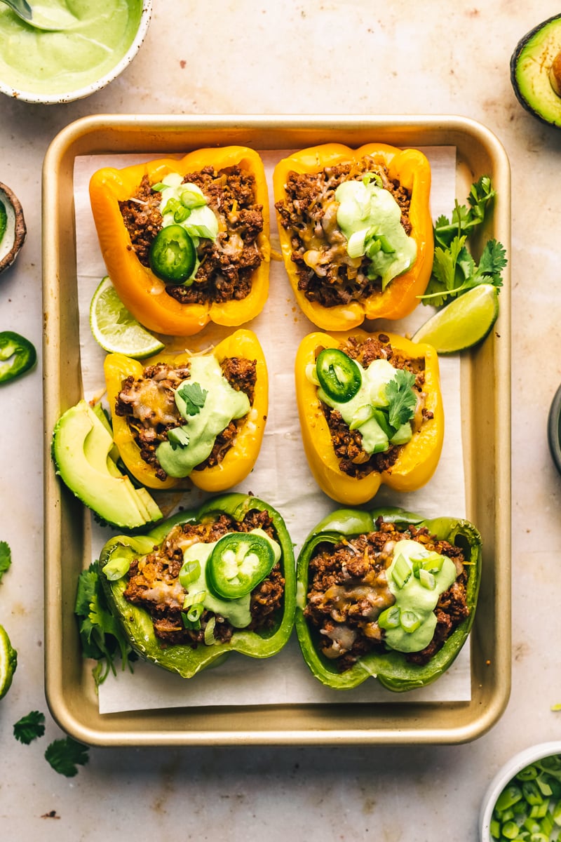 Taco stuffed peppers prepared on a baking tray for keto stuffed peppers recipe.