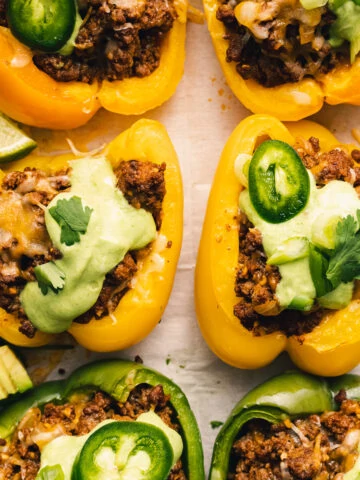 taco stuffed peppers with cilantro crema and toppings