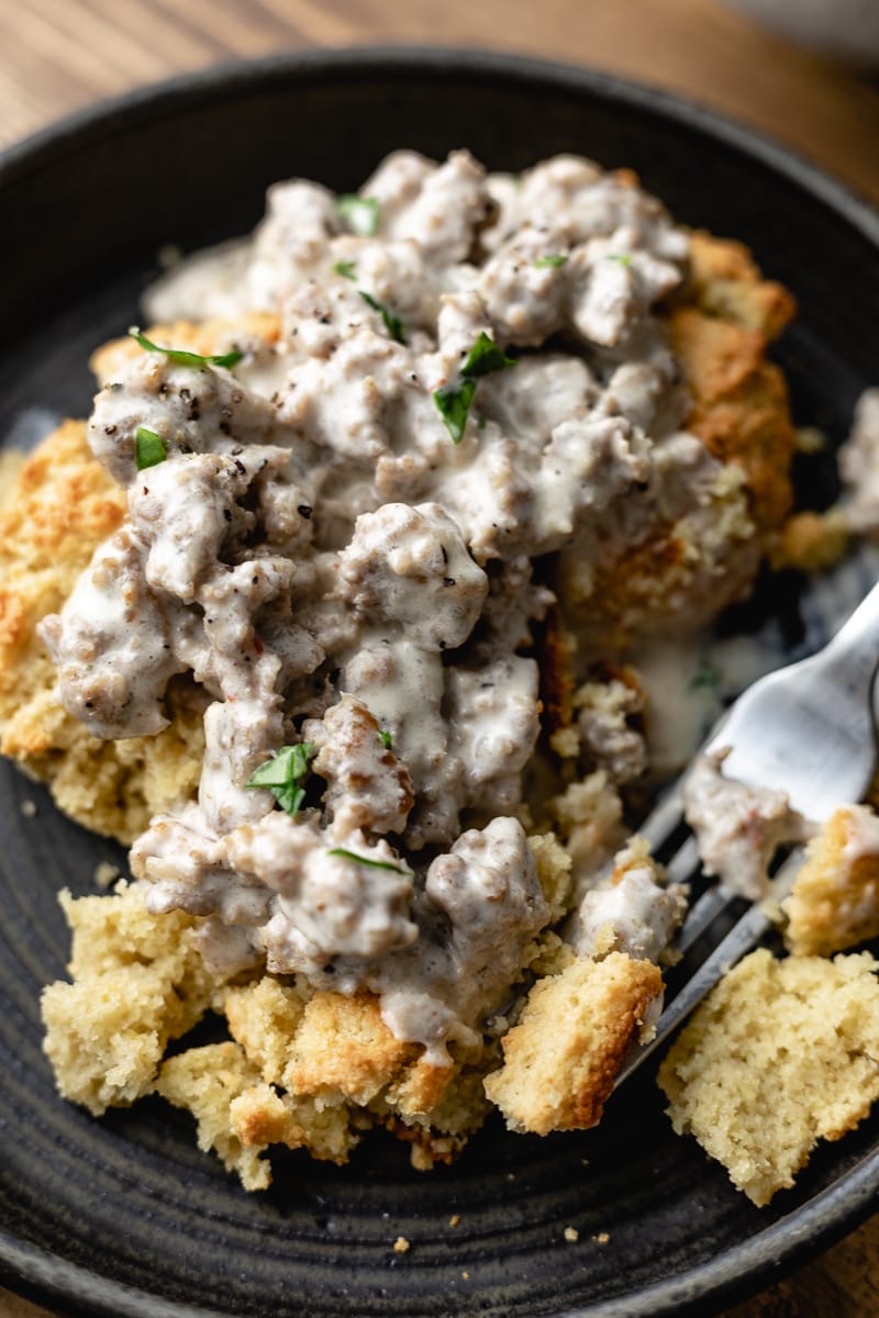 closeup of keto biscuits and gravy with a fork