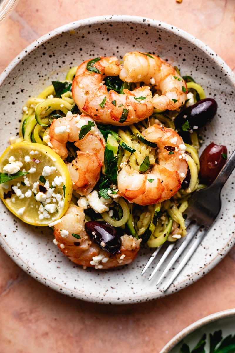 Mediterranean shrimp on a plate with vegetables and feta