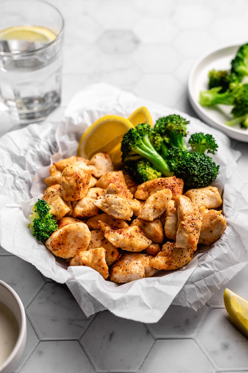 Air fryer chicken bites with side of broccoli and ranch dressing.
