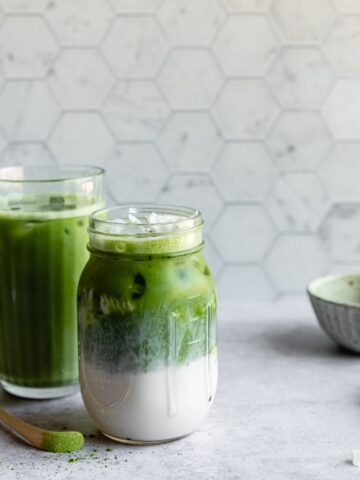 Matcha milk teas with a marble hexagon backdrop.