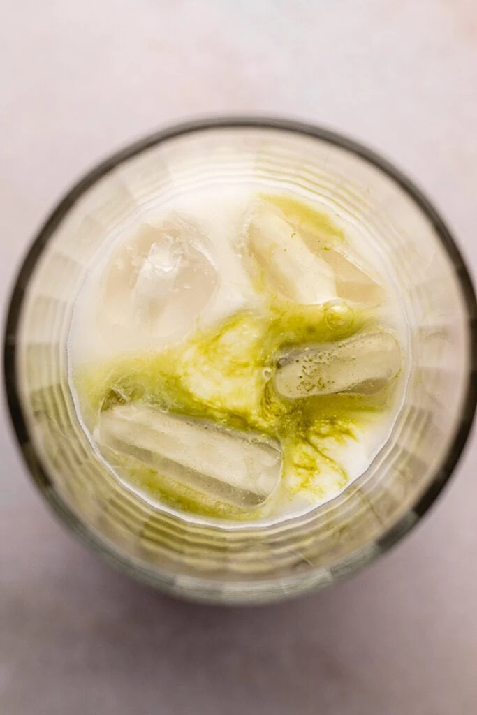 Matcha with cream in a glass with ice.