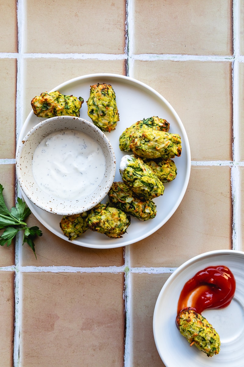 Air fryer veggie tots with ranch on a plate.