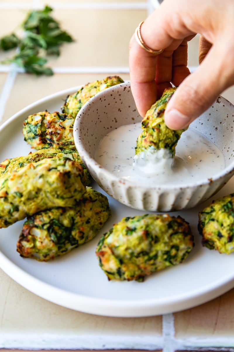 Dipping air fryer veggie tots in ranch.