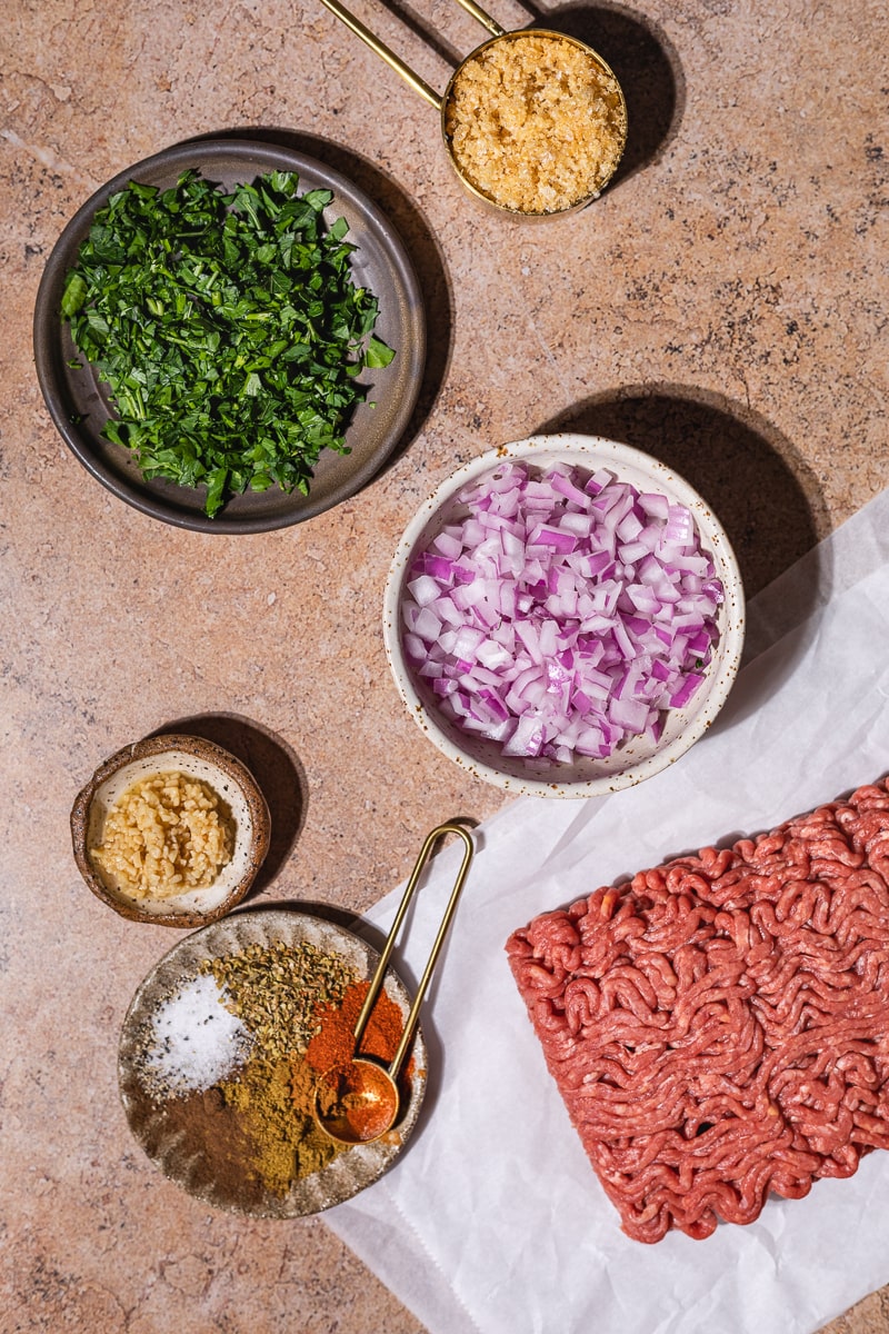Ingredients for Mediterranean ground beef kabobs in small dishes.