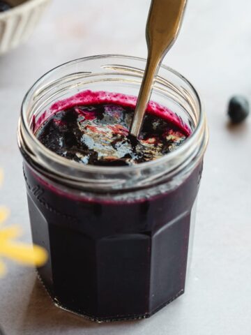 Sugar-free blueberry jam in a glass jam jar.