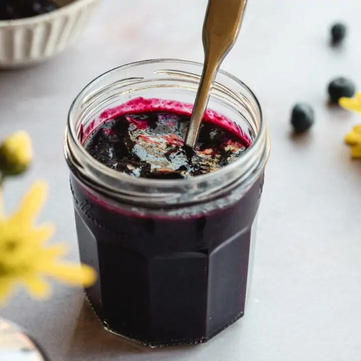 Sugar-free blueberry jam in a glass jam jar.