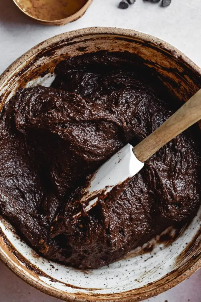 Spatula in a bowl of brownie batter.