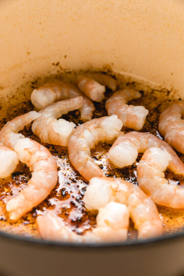 Shrimp sizzling in cast iron pot.