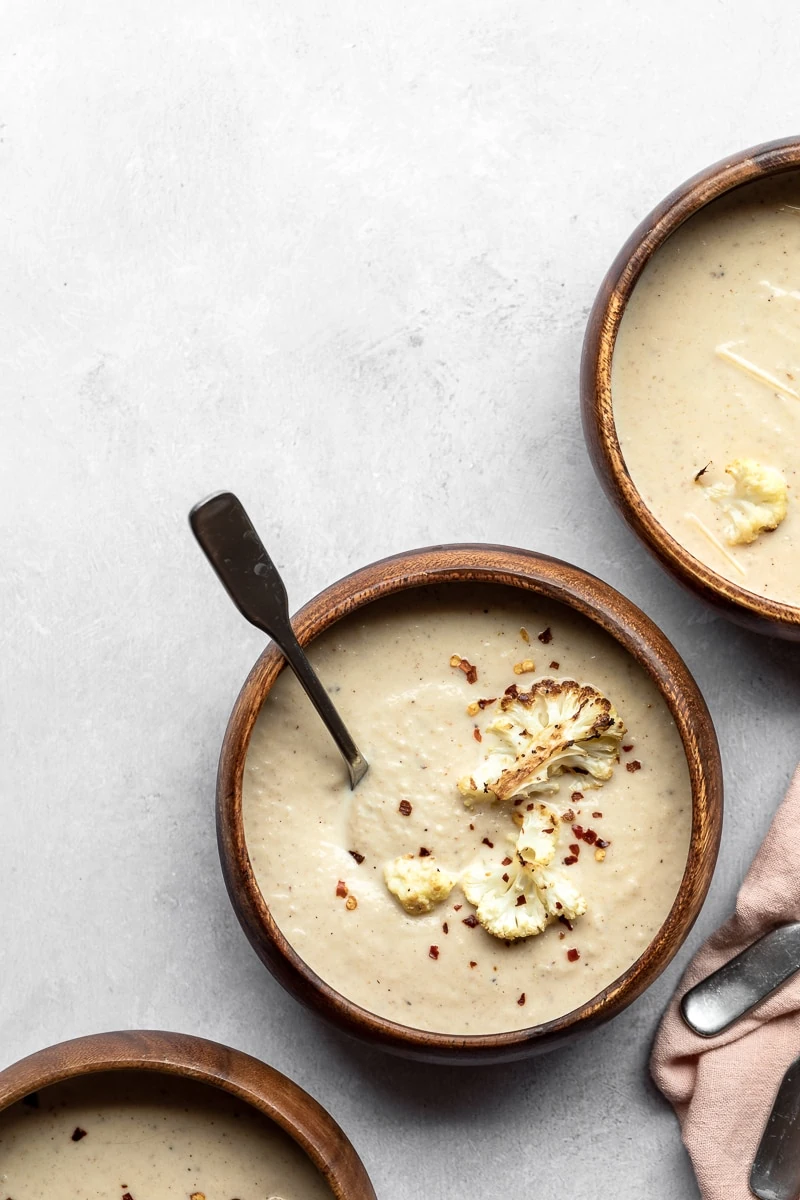 Three bowls of keto roasted cauliflower soup.