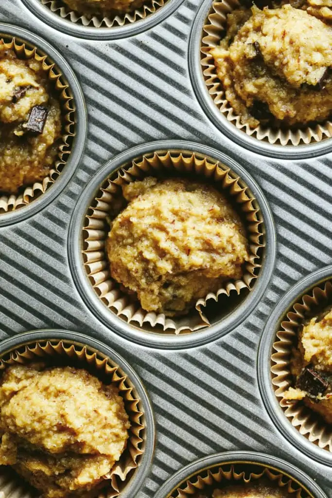 Closeup of almond flour banana muffin batter in a baking tin.