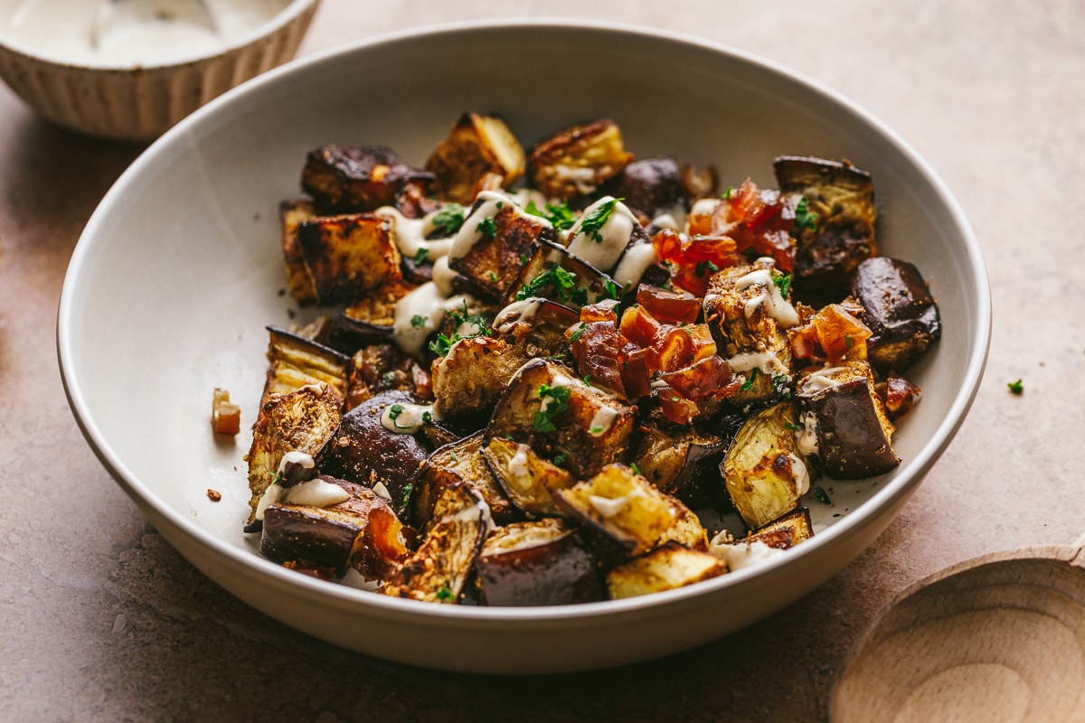 Bowl of Mediterranean roasted eggplant on a table.