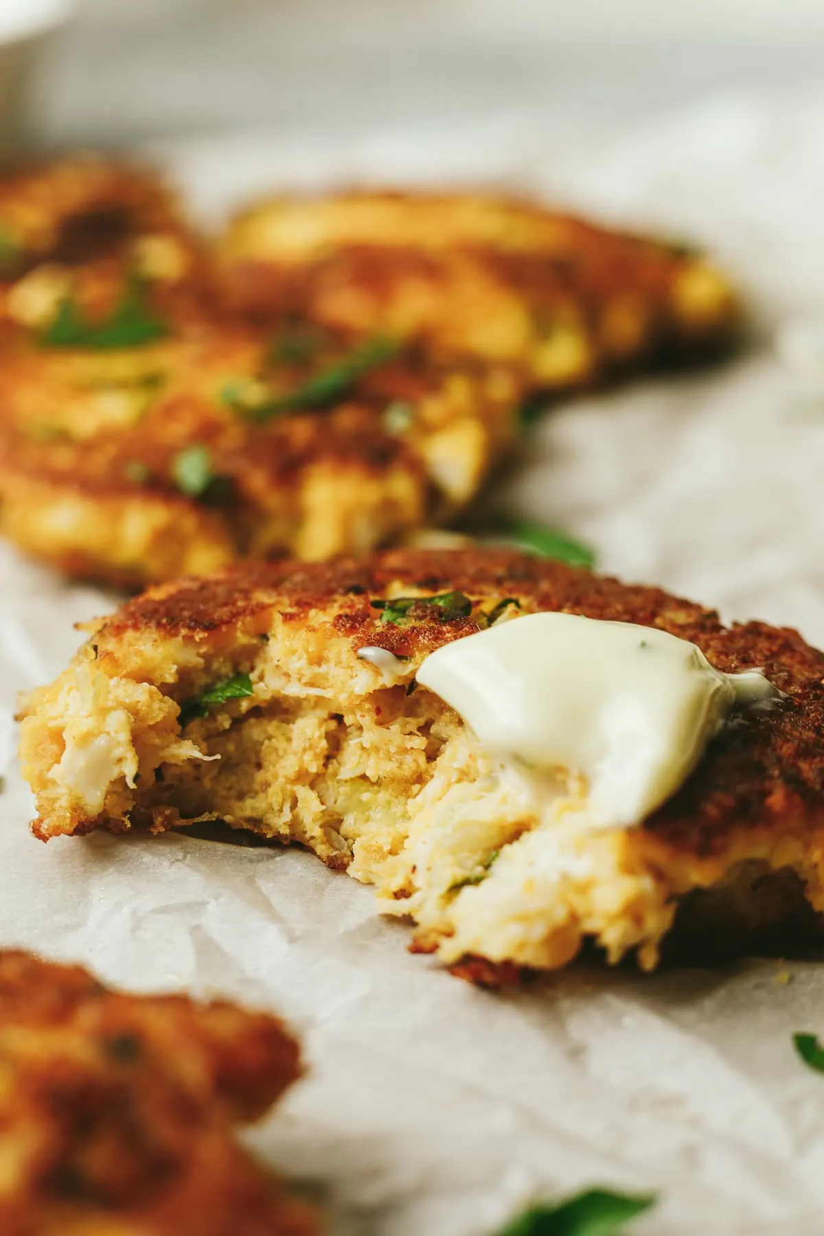 Closeup of a keto crab cake with garlic aioli on it.