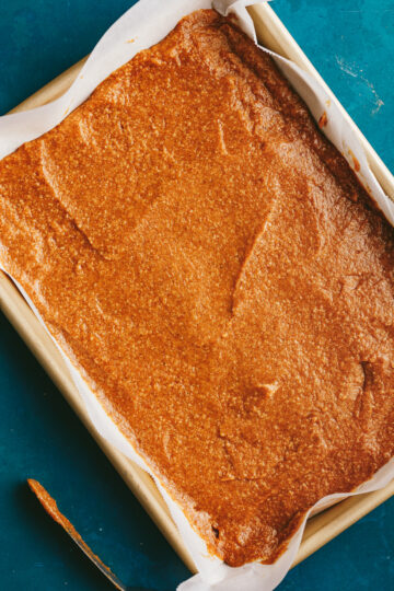 Jelly roll pan with pumpkin cake batter.