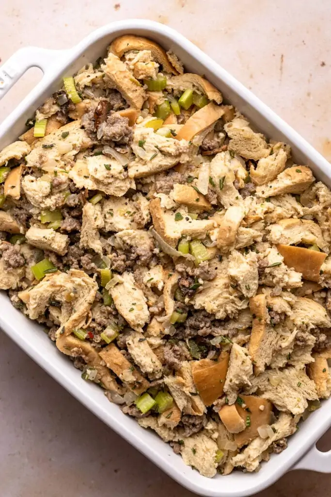 Unbaked keto stuffing in a white casserole dish.