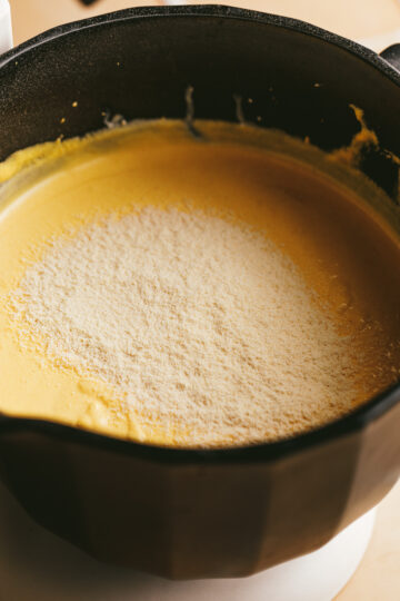 Closeup of the coconut flour on top of cheesecake batter.