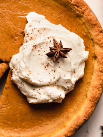 Closeup of sugar-free whipped cream on top of a pumpkin pie.