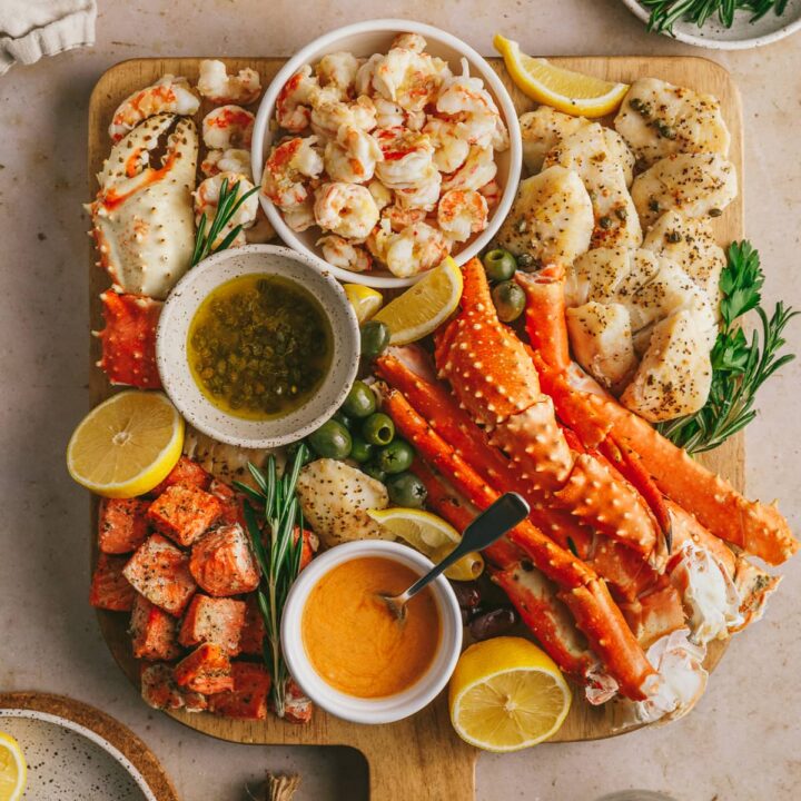Seafood charcuterie board styled with lots of cooked seafood.