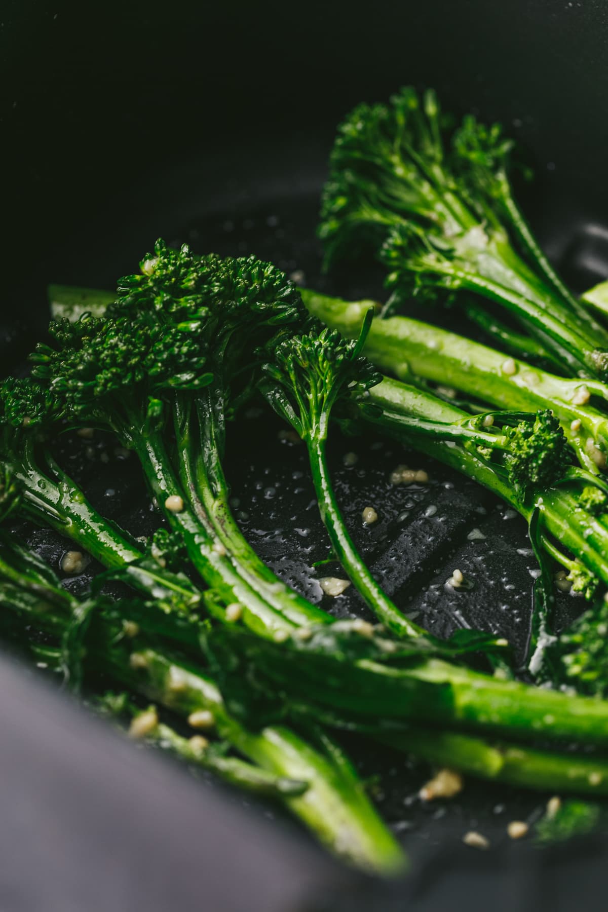 Broccolini in the air fryer basket.