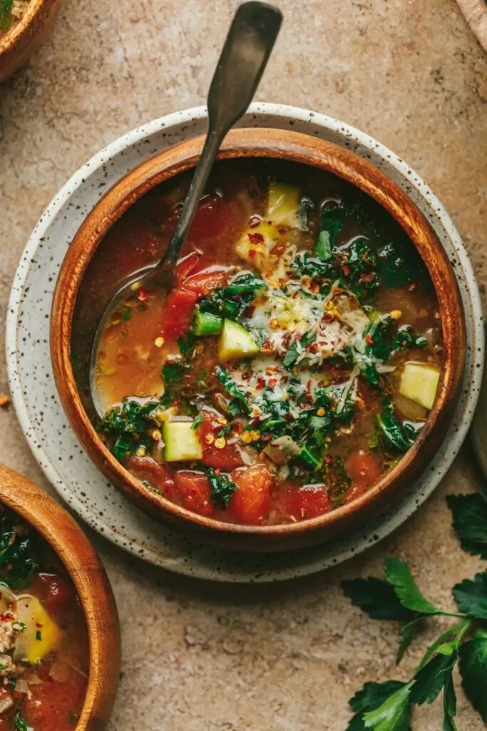 One bowl of keto Tuscan soup with parsley on the side.