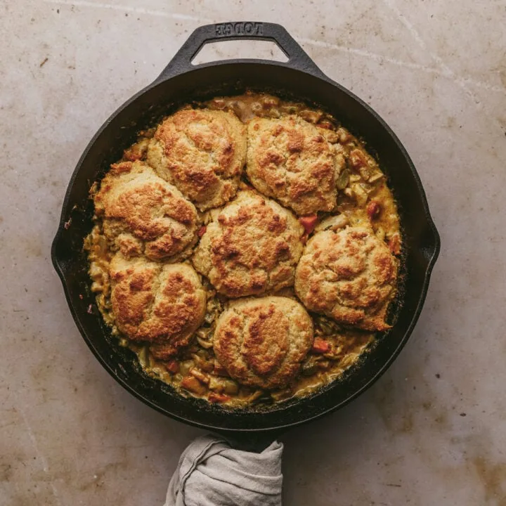 Keto chicken pot pie with biscuits in a cast iron skillet.