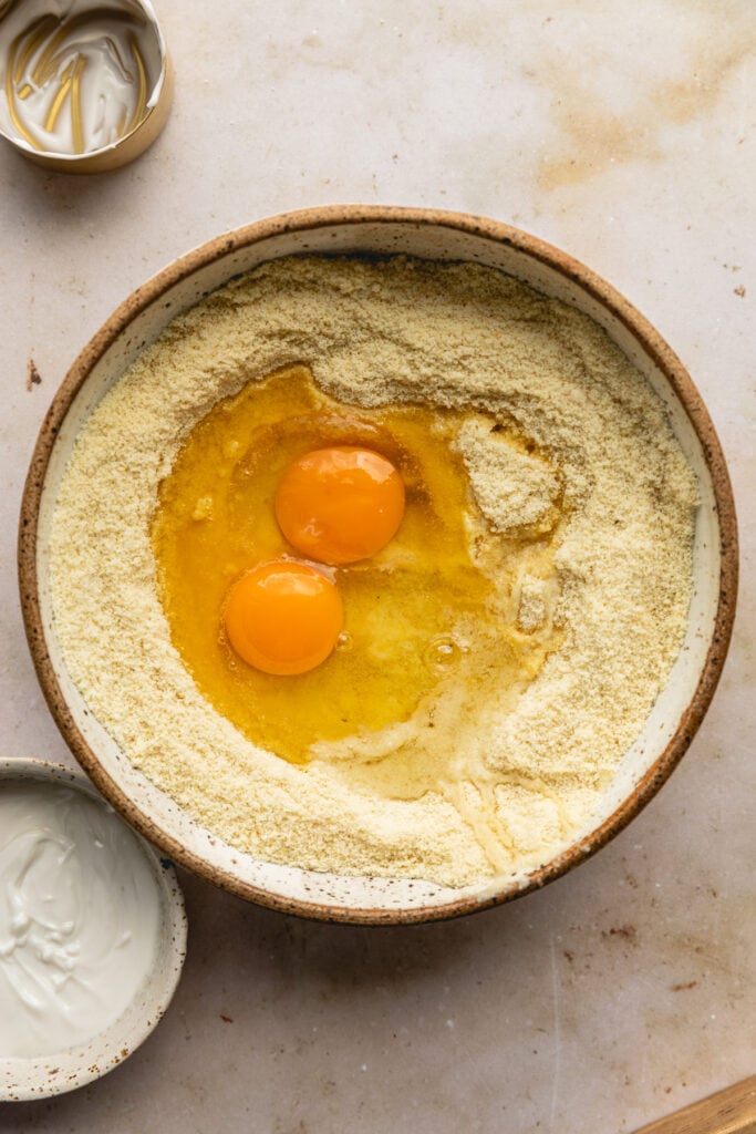Eggs and almond flour in a bowl for low-carb biscuits.