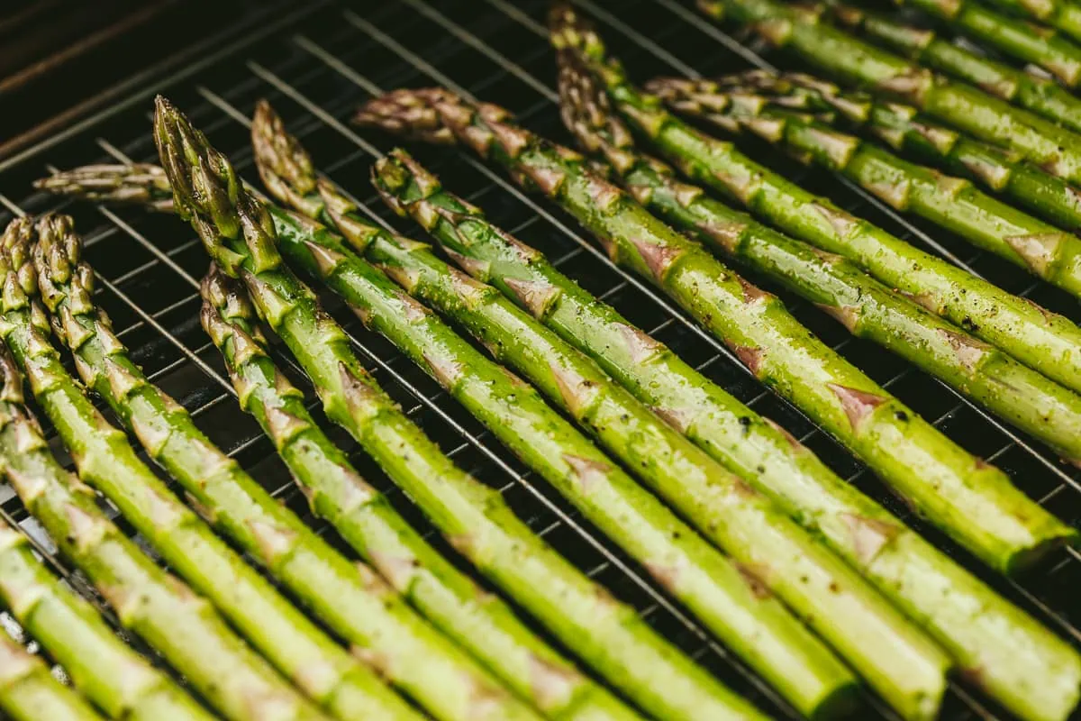 Asparagus spears on grill grate for Traeger asparagus recipe.