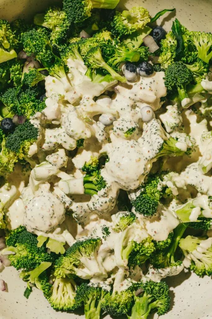 Closeup of dressing on broccoli florets for keto broccoli salad recipe.